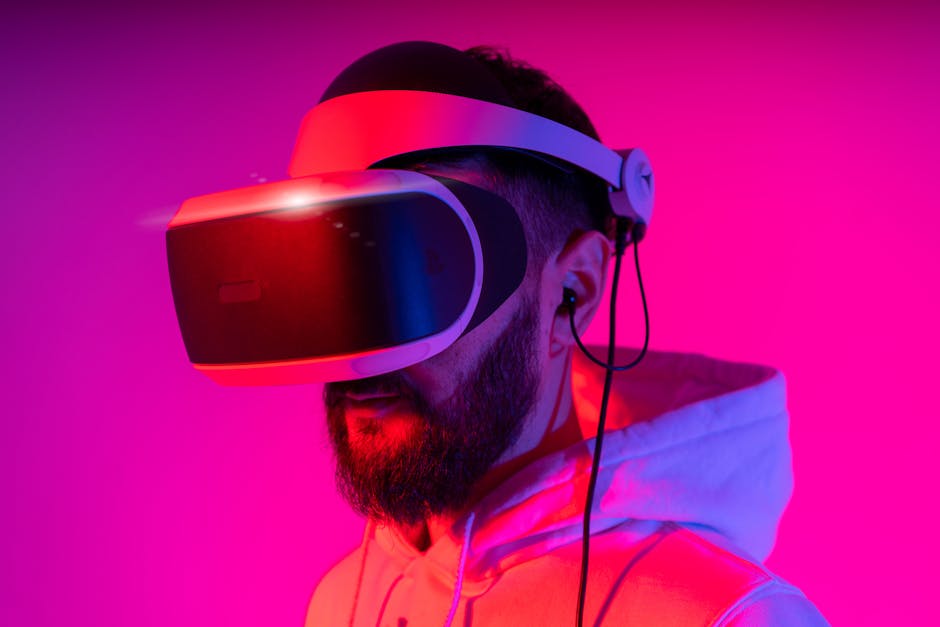 A man wearing a VR headset is immersed in virtual reality, illuminated by vibrant pink lighting